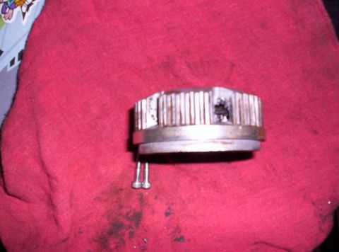 1995 Ford Bronco - Close-up of a metal component with fins and screws, likely a vehicle part.