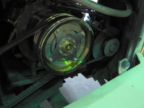 1979 Ford Bronco - Close-up view of an engine's pulley system, a prominent, multi-groove pulley and associated belts.