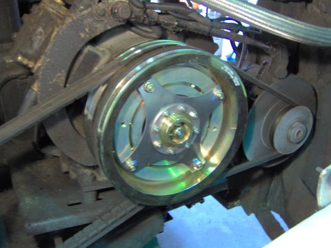 1979 Ford Bronco - A close-up view of the engine's pulley system, showing the belts and a central component.