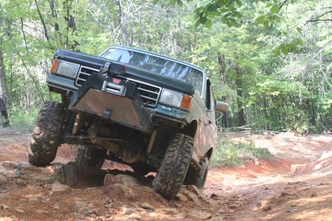 1990 Ford Bronco - A modified Ford Bronco navigates a challenging off-road course.