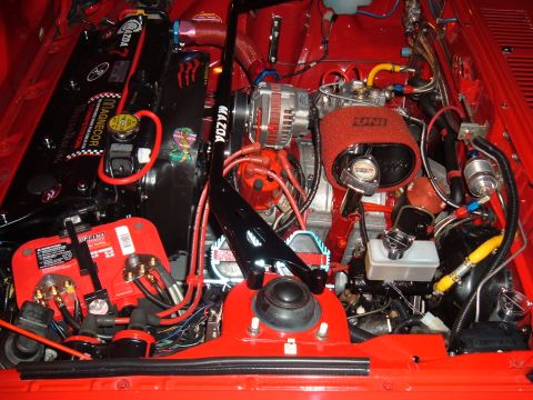 1991 Ford Probe - A detailed view of a modified Mazda engine bay, various aftermarket parts and clean wiring.