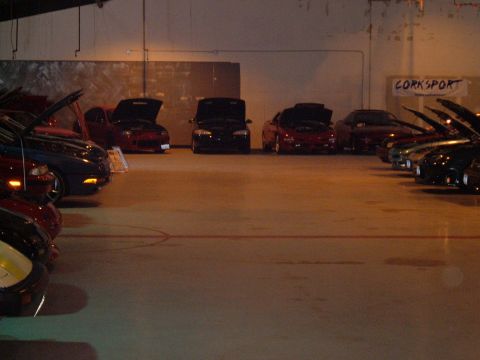 1991 Ford Probe - Indoor car meet with multiple vehicles displaying their engines.