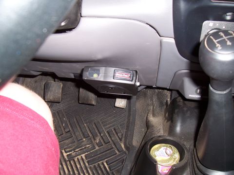 2003 Ford Ranger - Black electronic controller box mounted beneath the dash above clutch and brake pedals, with manual shifter at right.