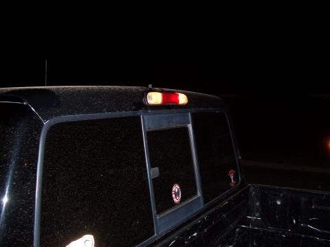 2003 Ford Ranger - Rear side view of a 2003 Ford Ranger pickup truck at night.