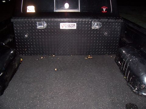 2003 Ford Ranger - Black diamond-plate Tractor Supply Co. crossover toolbox installed in a bed-lined pickup truck bed, shown at night.