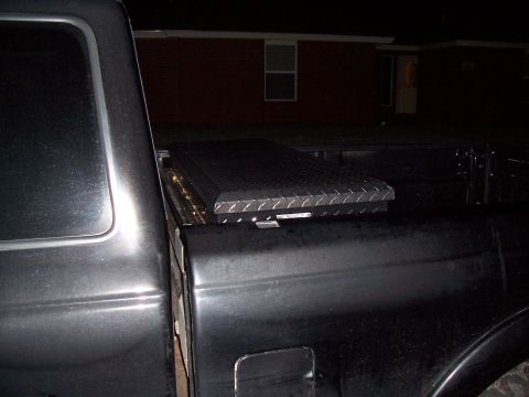 2003 Ford Ranger - A diamond plate toolbox is secured in the bed of a pickup truck at night.