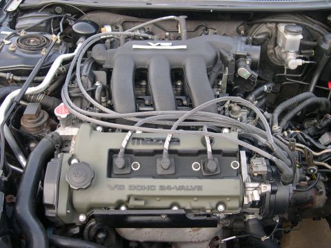1997 Ford Probe - Close-up view of a Mazda V6 engine, showing the intake manifold and valve cover with visible text.