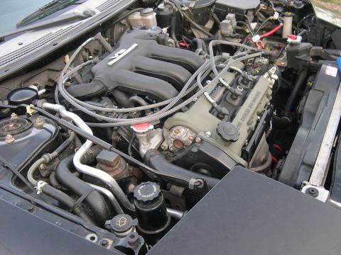 1997 Ford Probe - The engine bay of a 1997 Ford Probe is visible, displaying its V6 engine components.