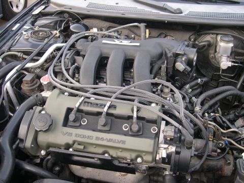 1997 Ford Probe - Close-up view of a Mazda V6 DOHC 24-valve engine, showing various hoses and components.