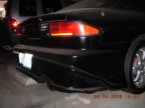 1993 Ford Probe - Rear section of a black car, showing custom bodywork and taillight detail.