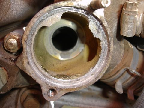 1993 Ford Taurus - This engine component has a damaged mounting flange, indicating potential issues with its seal or structural integrity.