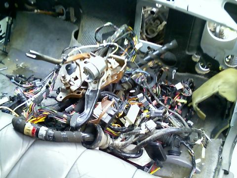 2002 Ford Crown Victoria - The complex interior wiring harness of a vehicle is visible, with many wires and connectors exposed.