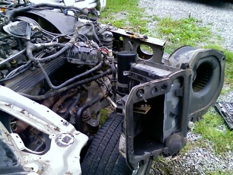 2002 Ford Crown Victoria - Front end components and engine of a car are disassembled and laid out.