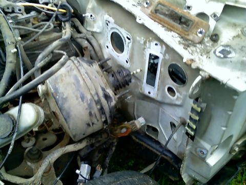 2002 Ford Crown Victoria - The firewall of a vehicle's engine bay shows exposed components and wiring.
