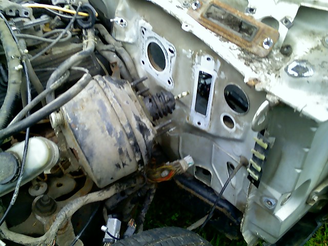 Engine bay firewall with brake booster, master cylinder, and wiring harness visible