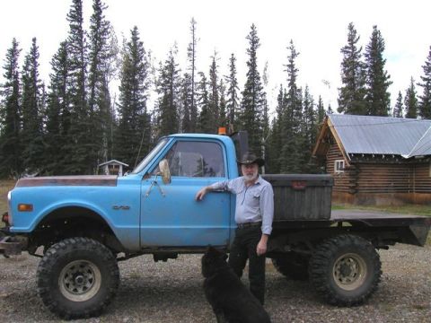 1976 Ford F-150 - Man and his dog pose with a modified pickup truck in a rural setting.