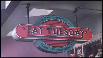 1993 Ford Taurus - A sign for Fat Tuesday advertises food and frozen drinks, with text indicating it's from Bourbon Street.