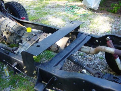 1991 Ford Bronco - The frame and drivetrain components of a vehicle are shown during assembly or repair.
