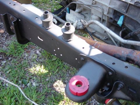 1991 Ford Bronco - Close-up view of a vehicle's chassis frame, highlighting the bushings used in its assembly.