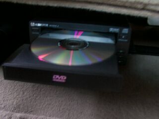 2001 Ford Excursion - The player is under just about center line with the vehicle, the remote makes it easy to run everything