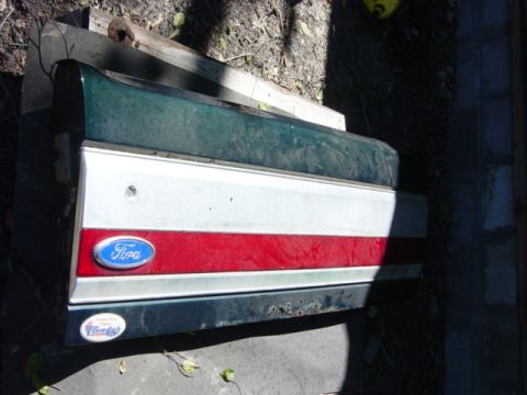 1991 Ford Bronco - Tailgate from a 1991 Ford Bronco, a red stripe and the iconic Ford emblem.