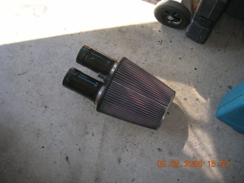 1996 Ford Bronco - Dual intake air filter with black pipes and a purple filter element on concrete.