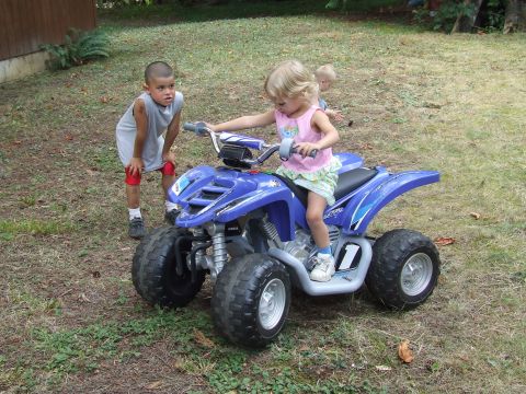 1976 Ford F-150 - Children interact with a blue ATV in a grassy outdoor setting.