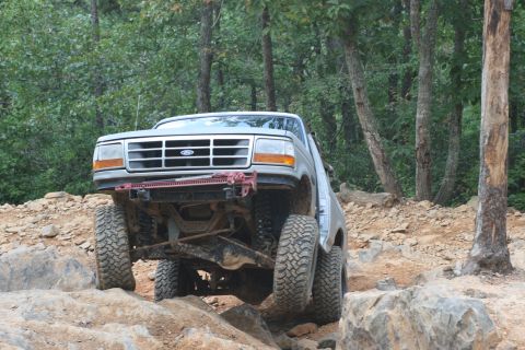 1990 Ford Bronco - 1990 Ford Bronco navigating a rocky off-road course.