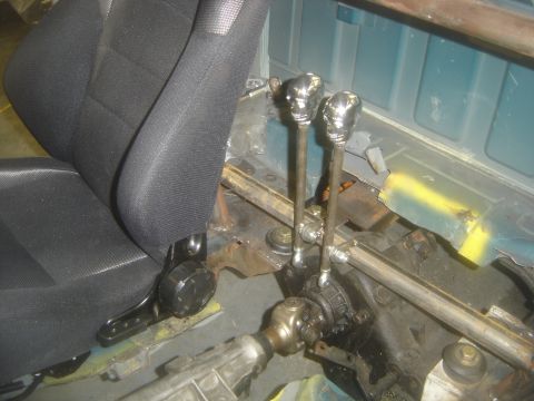 1997 Ford Ranger - Custom skull shifter knobs are installed in the transmission tunnel of a vehicle.