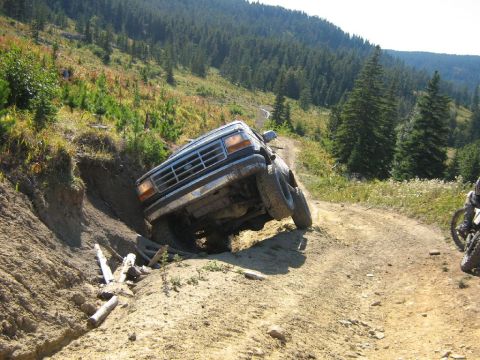 1995 Ford Bronco - This 1995 Ford Bronco is stuck on a steep, rutted dirt road with its front wheel in a ditch.