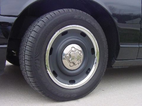 2003 Ford Crown Victoria - A close-up view of a vehicle's wheel and tire, showing the tread pattern and rim details.
