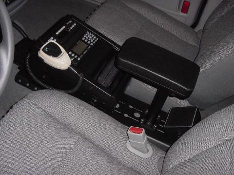 2003 Ford Crown Victoria - Interior view of a police car's center console with radio and armrest.