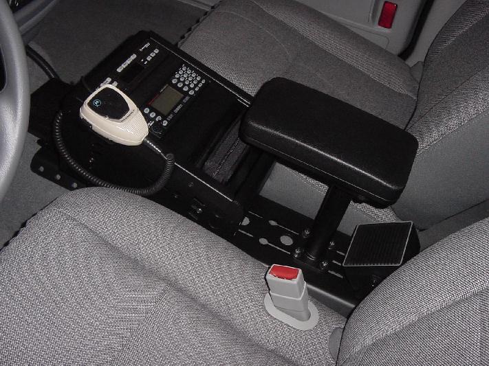 Center console with mounted two-way radio, mic, armrest and gray cloth seats