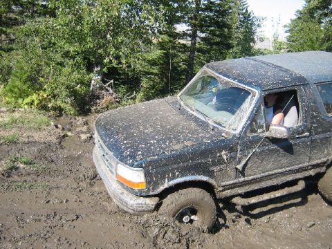 1995 Ford Bronco - This 1995 Ford Bronco is deeply stuck in mud, with its front end partially submerged.