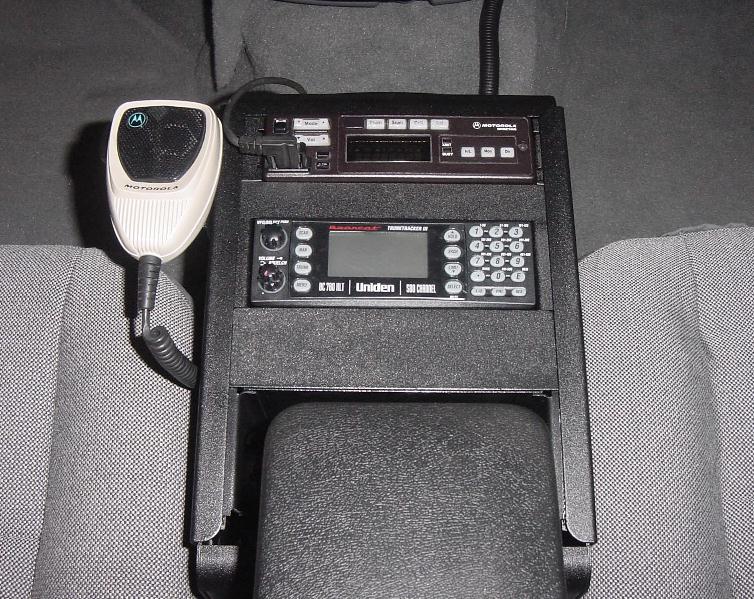 Motorola mic, radio head and Uniden Bearcat scanner mounted in vehicle center console