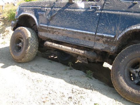 1995 Ford Bronco - This mud-splattered 1995 Ford Bronco is captured from the side, its off-road capabilities.