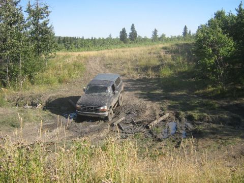 1995 Ford Bronco - A Ford Bronco attempts to drive through a muddy obstacle course.