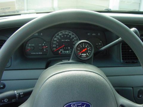 2003 Ford Crown Victoria - Interior view of a 2003 Ford Crown Victoria, the dashboard and a mounted tachometer.