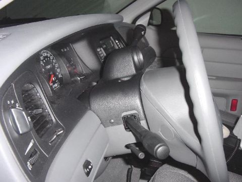 2003 Ford Crown Victoria - The interior of a 2003 Ford Crown Victoria, with a focus on the driver's side controls and dashboard.