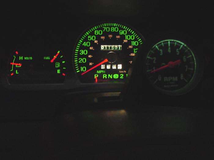 Illuminated instrument cluster with speedometer and tachometer