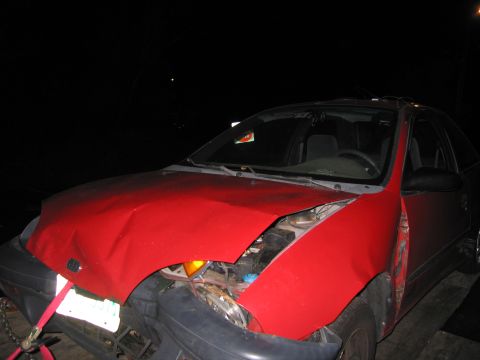 1991 Ford LTD Crown Victoria - This red car sustained significant front-end damage and appears to be in the process of being towed.