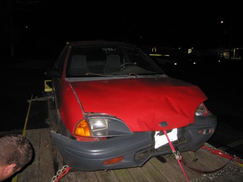 1991 Ford LTD Crown Victoria - Front view of a red car with significant damage to its hood and bumper.