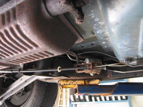 1991 Ford LTD Crown Victoria - A close-up shot of the undercarriage of a vehicle, revealing its exhaust system and fuel lines.