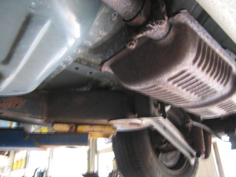 1991 Ford LTD Crown Victoria - The underside of a vehicle is visible, with focus on the exhaust system and frame.