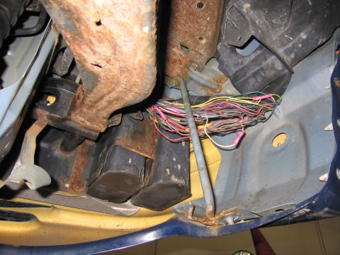 1991 Ford LTD Crown Victoria - Vehicle wiring harness with numerous wires and rusty metal parts visible.