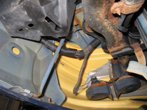 1991 Ford LTD Crown Victoria - Underside view of vehicle's electrical wiring and horn assembly, with visible signs of wear and corrosion.