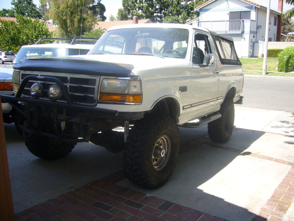 White 1992 Ford Bronco with lifted suspension and off-road bumper