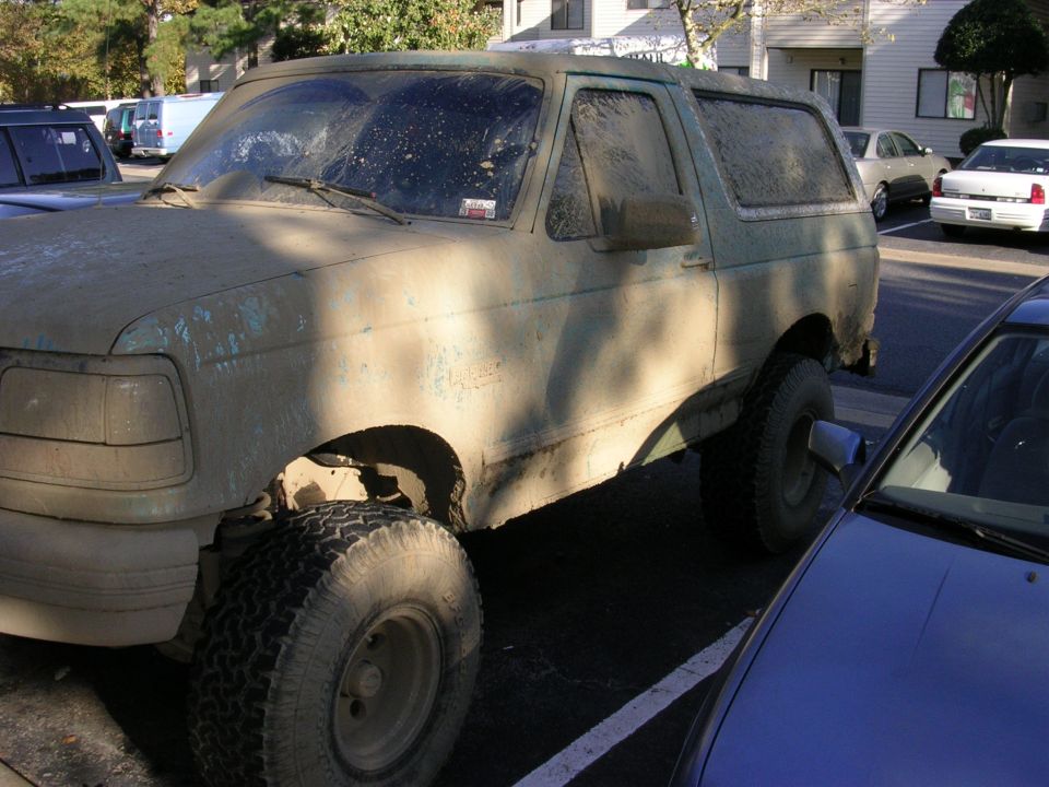 Mud-covered 1994 Ford Bronco, 3q-front view