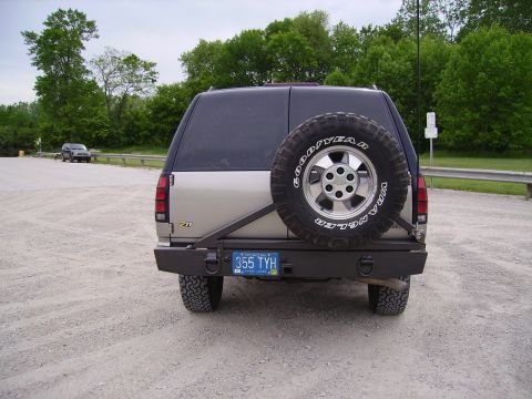 2000 Chevrolet Tahoe - This SUV features a rear-mounted spare tire and an aftermarket bumper.