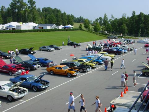 1986 Ford Mustang - A collection of classic Ford Mustangs are displayed at an outdoor event.